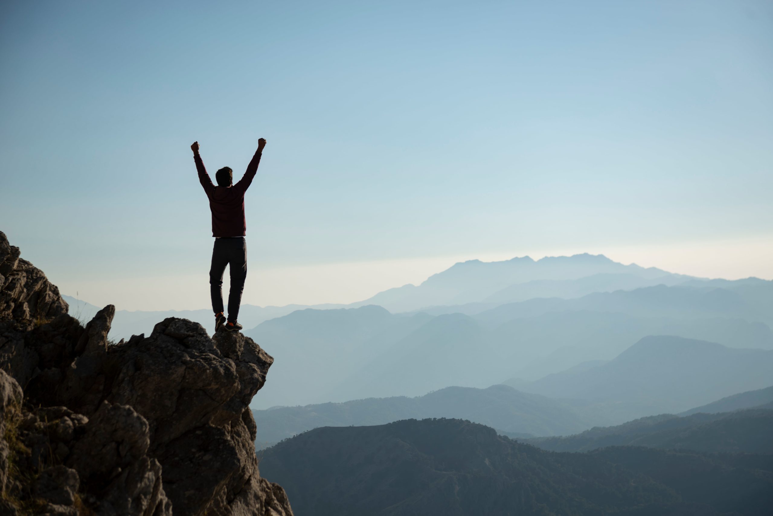 man stood on cliff top, resilience building