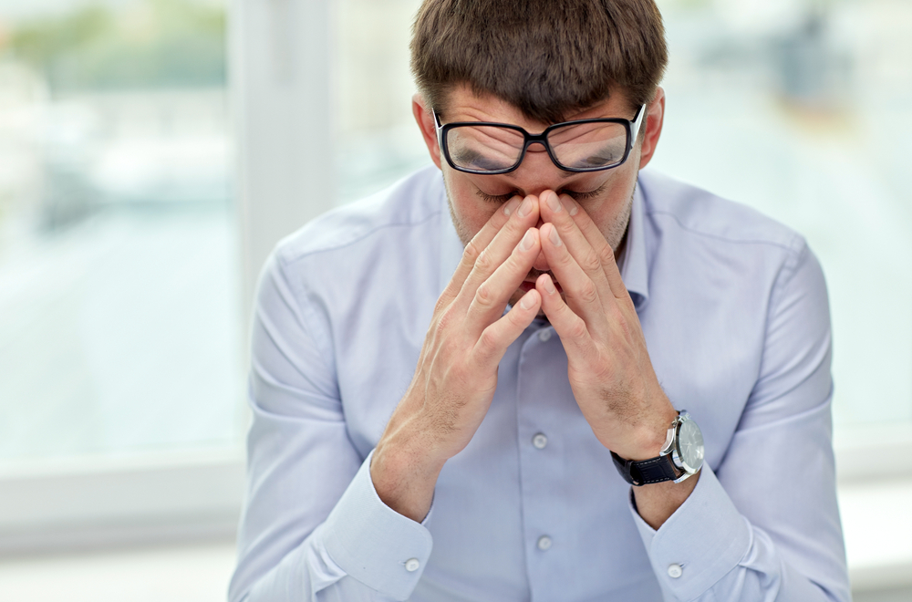 stressed man sat in office