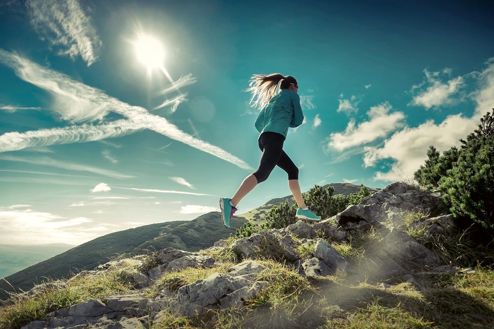 woman running up a mountain