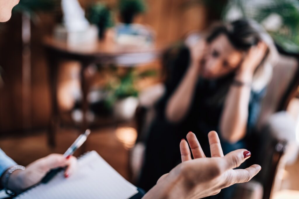 trauma therapist speaking to client during therapy session